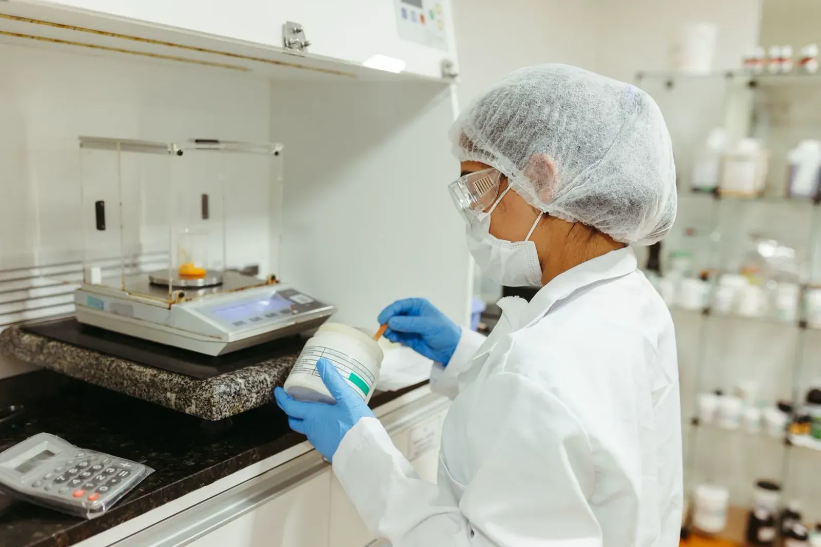 Laboratory technician using a precision balance Fisher Scales Norfolk
